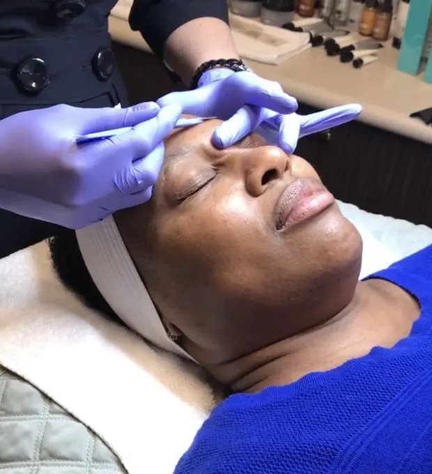 woman getting a facial treatment, dermaplaning