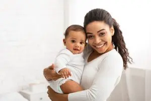Woman holing a baby in her arms