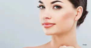 woman touching her neck